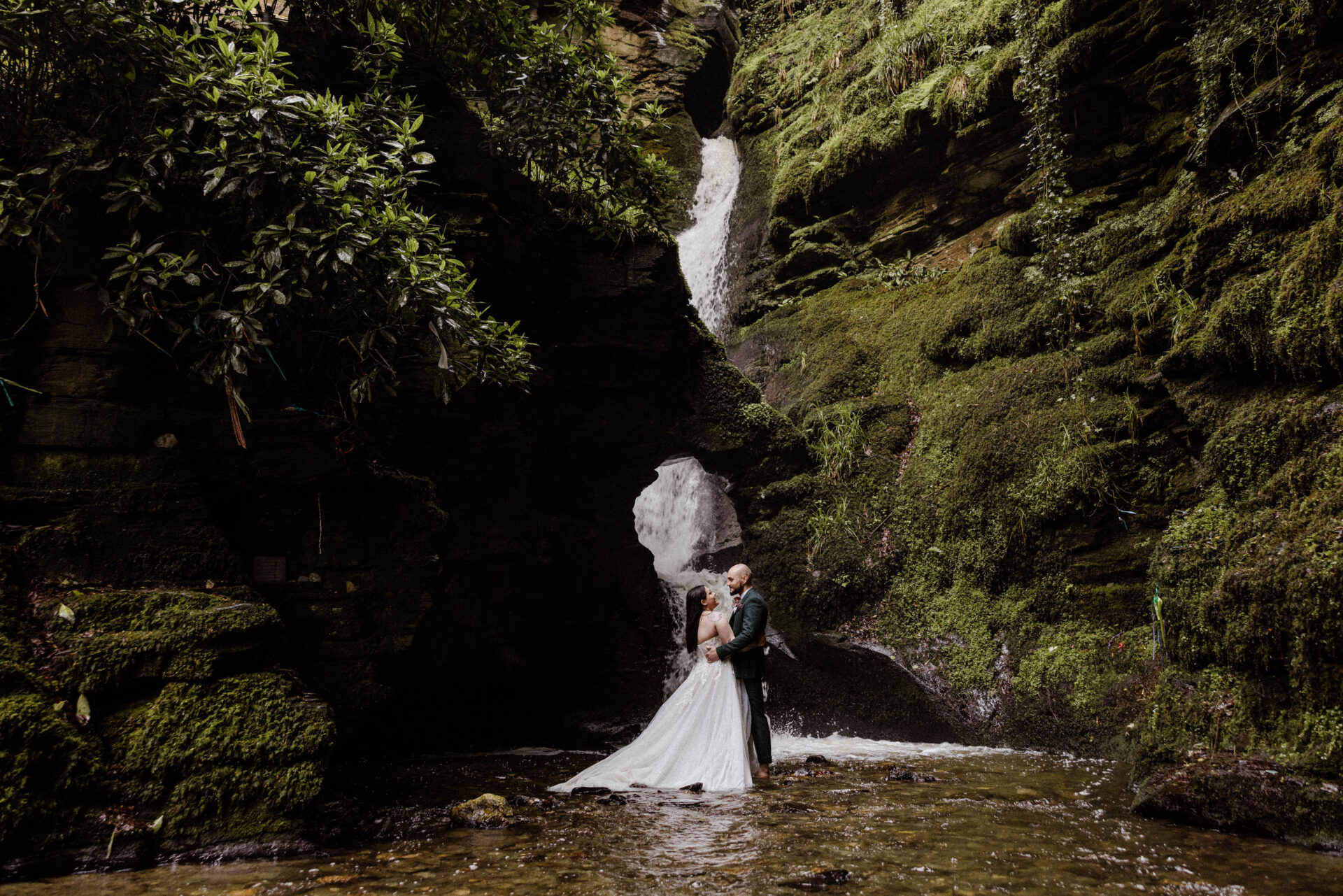 A couple celebrating a wedding at St Nectans' Glen Waterfall